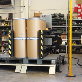 stationary pallet changer side mover with cardboard drums