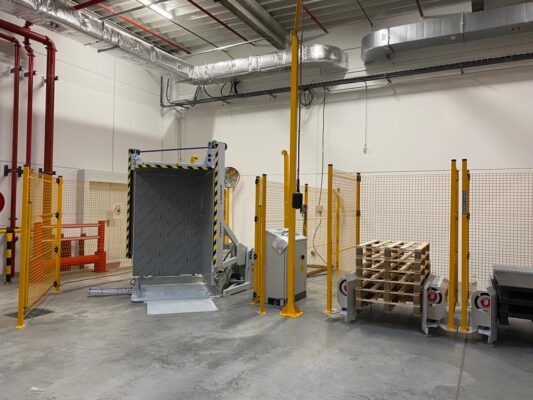 Pallet tipper with pallet dispenser